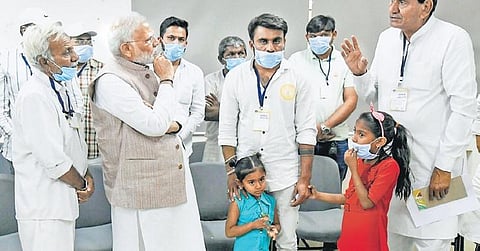 PM Narendra Modi  meets family members of victims of the suspension bridge collapse, in Morbi on Tuesday. (Photo| PTI)