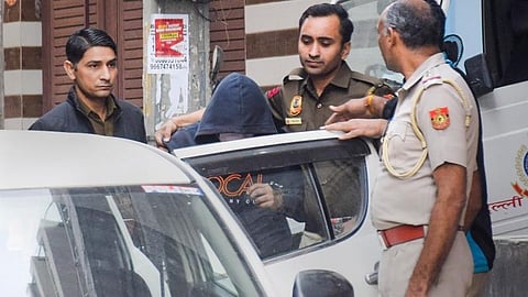 FILE | Aaftab Poonawala, accused of killing his partner Shraddha Walkar, being brought to his residence at Chhatarpur as part of the ongoing investigation.
