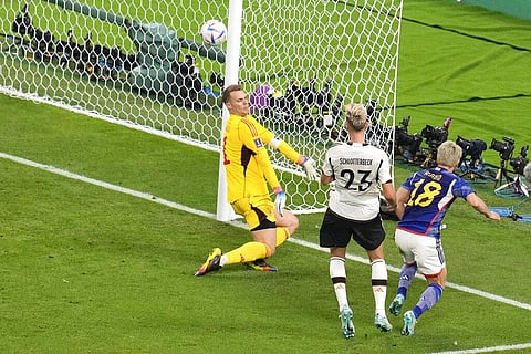 Takuma Asano, (R), scores Japan's winning goal against Germany in the Group E fixture of the FIFA World Cup at the Khalifa International Stadium in Doha, Nov. 23, 2022. (Photo | AP)