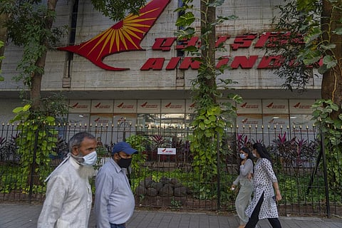 In this representational image, people walk past Air India headquaters in Mumbai, India, Jan. 27, 2022. (Photo | AP)