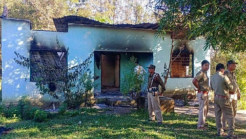 Security personnel stand guard near a forest office, a day after it was vandalised and burnt down by miscreants at a disputed Assam-Meghalaya border location that killed six people. (Photo | PTI)