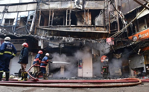 Fire officials trying to douse fire at Bhagirath Palace market of Chandni Chowk where a fire broke out last night in New Delhi, Nov. 25, 2022. (Photo | Shekhar Yadav, EPS)