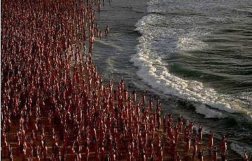 Participants pose nude during sunrise on Sydney's Bondi Beach for US art photographer Spencer Tunick, to raise awareness for skin cancer, on November 26, 2022 | AFP
