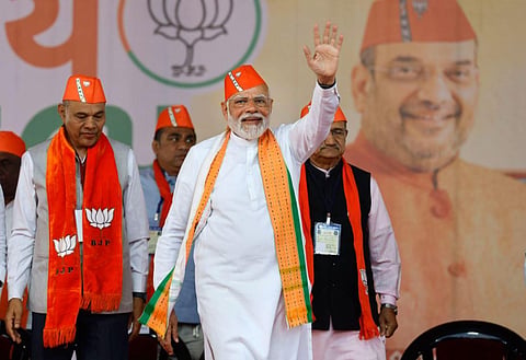 Prime Minister and senior BJP leader Narendra Modi waves at supporters at a public meeting ahead of the Gujarat Assembly elections, in Kheda district. (Photo | PTI)