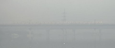 Time: 11am. Place: Yamuna Bridge. Date: Friday. The national capital was wrapped in thick blanket of smog, with zero visibily due to severe air pollution. (Photo | Shekhar Yadav)