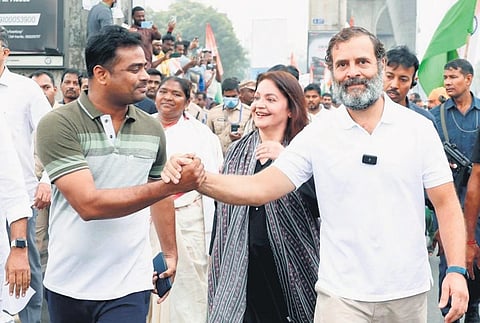 Congress MP Rahul Gandhi greets a supporter as actor Pooja Bhatt looks on  during his Bharat Jodo Yatra in Hyderabad on Wednesday