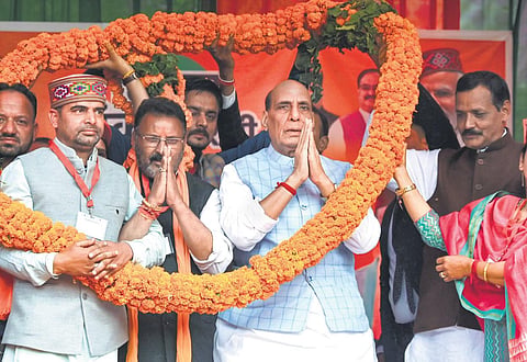 Defence Minister Rajnath Singh being garlanded during a public meeting, ahead of the Himachal Pradesh Assembly elections in Mandi on Monday. (Photo | PTI)