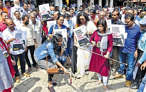Members of Yuktivadi Sangham burning hijab in solidarity with Iran’s anti-hijab movement, in Kozhikode on Sunday