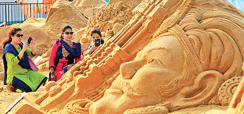 Visitors admire a sand art at Hampi Utsav. (File photo | EPS)