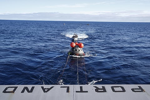 NASA's Orion capsule makes its way toward the U.S.S. Portland after being successfully secured by a NASA and U.S. Navy team (Photo | AP)