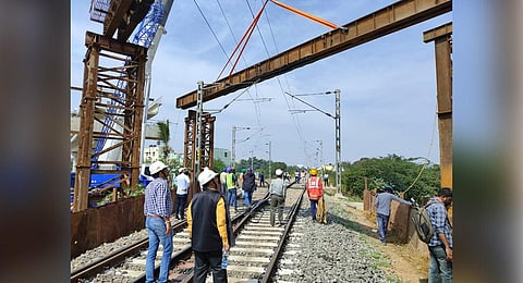 BMRCL personnel erect an open steel web girder, above the railway tracks, near Baiyappanahalli in Bengaluru on Sunday | Express  ​
