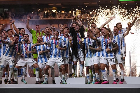 Argentina's players celebrate with the FIFA World Cup trophy at the Lusail Stadium in Qatar, Dec. 18, 2022. (Photo | AP)