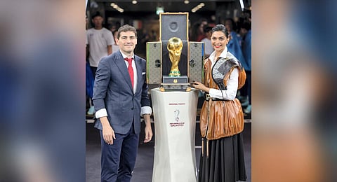 Bollywood actor Deepika Padukone with former Spanish footballer Iker Casillas unveils the FIFA World Cup trophy, at Lusail Stadium in Qatar. (Photo | PTI)