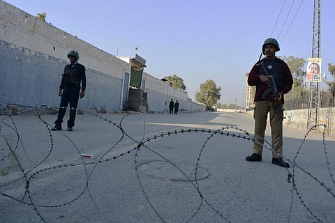 Security officials guard a blocked road leading to a counter-terrorism center after security forces starting to clear the compound seized earlier by Pakistani Taliban militants in Bannu. (Photo | AP)