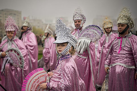 Performers wearing traditional Romanian costumes take part in a parade of winter traditions to ward off evil, in Bucharest, Romania. (Photo | AP)