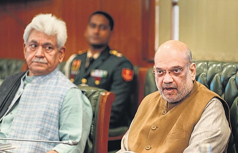 Home Minister Amit Shah (right) with Jammu and Kashmir L-G Manoj Sinha during  a meeting on Jammu and Kashmir, in New Delhi on Wednesday. (Photo | PTI)