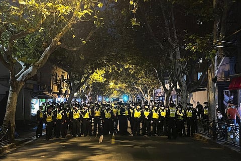 Chinese police officers block off access to a site where protesters had gathered in Shanghai, Nov. 27, 2022. (File Photo | AP)