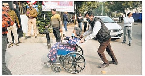 A wheelchair-bound voter arrives to cast her vote at a polling station | pti