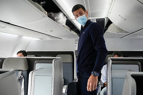 Novak Djokovic prepares to take his seat on a plane to Belgrade, in Dubai, United Arab Emirates. (Photo | AP)