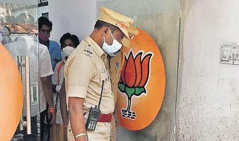 Police personnel at Kamalalayam, the BJP headquarters, after the petrol bomb hurling incident | R Satish Babu