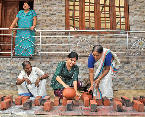 A family residing near Attukal Devi temple in Thiruvananthapuram making arrangements in front of their home on the eve of Pongala | B P Deepu