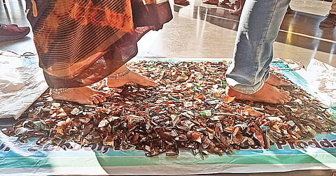 Jana Viganana Vedika made students walk barefoot on broken glass pieces with an objective to build self-confidence in them at the event in SPA. (Photo | EPS,P Ravindra Babu)