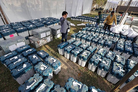 Election officials gather at a distribution center to receive electronic voting machines and other polling material. (Photo | AP)