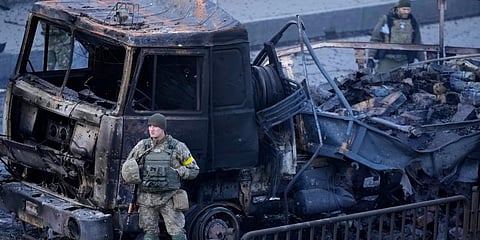 Ukrainian troops inspect the site following a Russian airstrike in Kyiv, Ukraine. (Photo | AP)