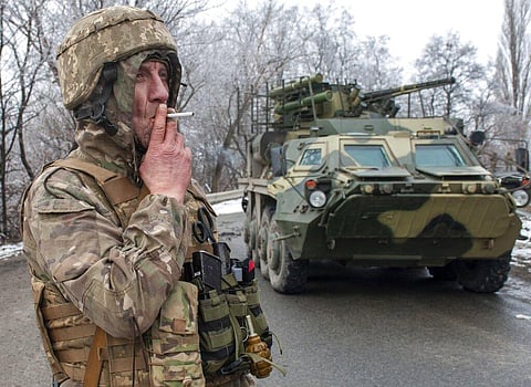 A Ukrainian soldier smokes a cigarette on his position at an armored vehicle outside Kharkiv, Ukraine. (Photo | AP)