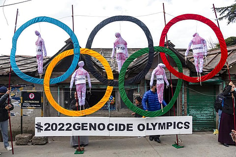 Exiled Tibetans use the Olympic Rings as a prop as they hold a street protest against the holding of 2022 Winter Olympics in Beijing in Dharmsala, India  (Photo | AP)