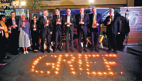 Ukraine envoy Igor Polikha (wearing specs in centre) with foreign diplomats at a candlelight vigil on Monday | SHEKHAR YADAV