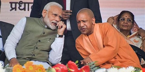 PM Narendra Modi (L) interacts with Uttar Pradesh CM Yogi Adityanath. (Photo | PTI)