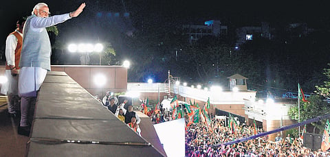 Prime Minister Narendra Modi waves at BJP workers during celebrations at the party headquarters in New Delhi on Thursday. (Photo  | PTI)