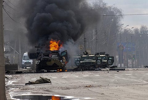 A Russian armored personnel carrier burns amid damaged and abandoned light utility vehicles after fighting in Kharkiv, Ukraine. (File Photo | AP)