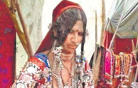Somavva Lamani gets to work on a dress at Kundaralli tanda. Somavva with other women of the Banjara community 