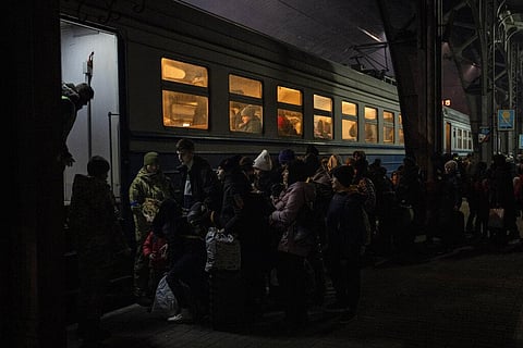 Displaced Ukrainians queue to board a Poland bound train in Lviv, western Ukraine, Sunday, March 13, 2022.(Photo | AP)