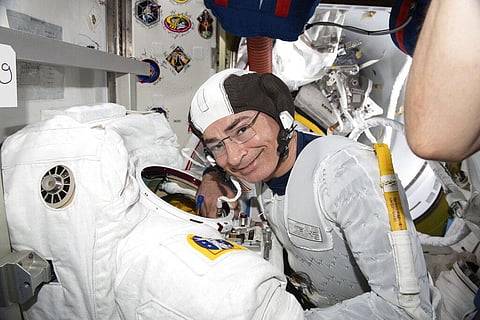 In this Aug. 17, 2021 photo made available by NASA, astronaut and Expedition 65 Flight Engineer Mark Vande Hei inspects a spacesuit. (Photo  | AP)