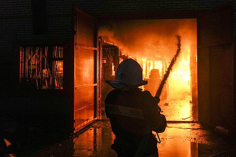 Ukrainian firefighters extinguish a blaze at a warehouse after a bombing in Kyiv, Ukraine, Thursday, March 17, 2022(Photo | AP)