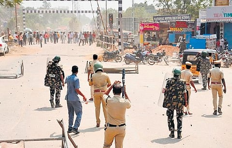 Police fire tear-gas shells to disperse two groups of activists who clashed during installation of a statue of Shivaji at Ambedkar Centre in Bodhan on Sunday