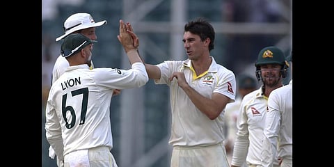 Australia's Pat Cummins celebrates after taking the wicket of Pakistan's Nauman Ali on the third day of the third test  in Lahore, Pakistan, Wednesday, March 23, 2022.(Photo | AP)