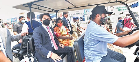 Union Minister Jyotiraditya Scindia and Governor Tamilisai Soundararajan use a golf cart to reach the airfield during the Wings India-2022 in Hyderabad on Friday | RV K Rao