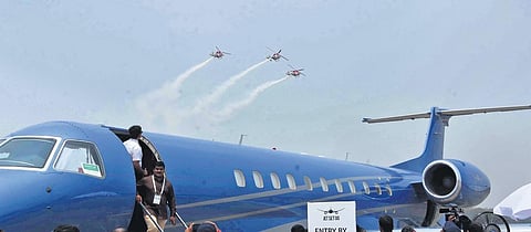 Sarang Helicopter aerobatic team passes above an Emberer aircraft on the 2nd day of Wings India-2022 | RV K Rao