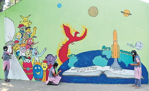 Students of Dr MGR Cantonment High School paint the school campus wall at St Thomas Mount  in Chennai city. (Photo | EPS)