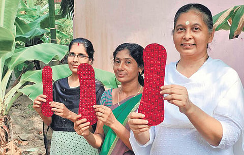 Anju Bist and her team with the world’s first reusable menstrual pads they made  from banana fibre, which comes from agro-waste