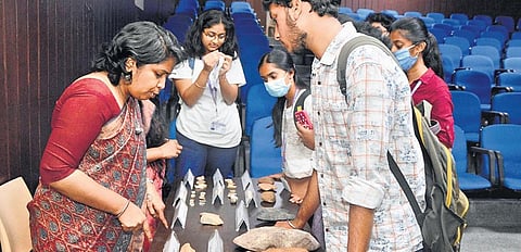 Superintendent Archaeologist Smita  S Kumar shows some artefacts to  students in Hyderabad on Monday. ( Photo | EPS)