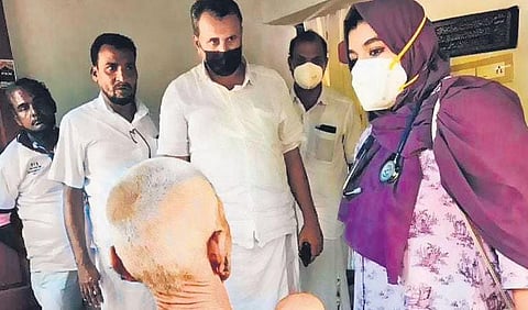 Team members of We R Health attend to a patient
