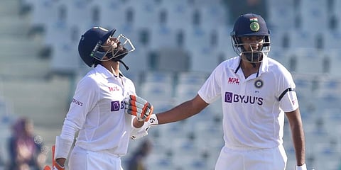 ndia’s Ravichandran Ashwin congratulates teammate Ravindra Jadeja after the latter scored a half-century, during the 2nd day of the 1st test cricket match between India and Sri Lanka. (PTI)
