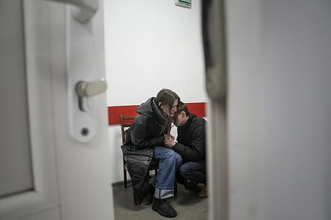 Marina Yatsko and her boyfriend Fedor comfort each other after her 18-month-old son Kirill was killed by shelling in a hospital in Mariupol, Ukraine, Friday, March 4, 2022. (AP Photo)