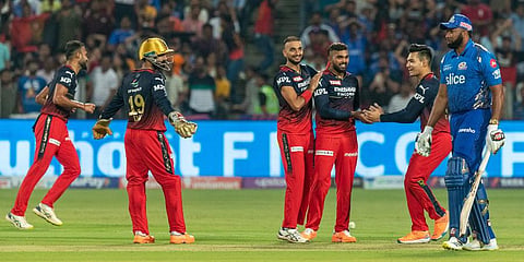 Wanindu Hasaranga of RCB celebrates with teammates after the wicket of Kieron Pollard of Mumbai Indians during the IPL match at the MCA International Stadium in Pune. (Photo | PTI)