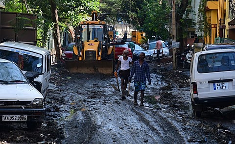 Residents having difficult time after  heavy downpour on Thursday late evening near kamakya theatre in Banashankari. BBMP workers were seen clearing water. (Photo | Shriram BN, EPS)